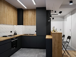 Mieszkanie 53m2 Bemowo - Średnia otwarta czarna szara z zabudowaną lodówką z lodówką wolnostojącą z nablatowym zlewozmywakiem kuchnia w kształcie litery u, styl nowoczesny - zdjęcie od DEDEKO