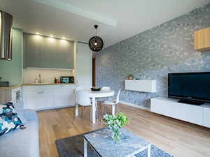 Realizacja nadmorskiego apartamentu - Średni salon z kuchnią z jadalnią, styl skandynawski - zdjęcie od MOA design