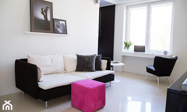 czarno-biała sofa i różowa kostka do siedzenia
