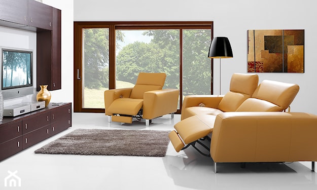 żółta sofa, brązowy dywan, lampa podłogowa z czarnym abażurem