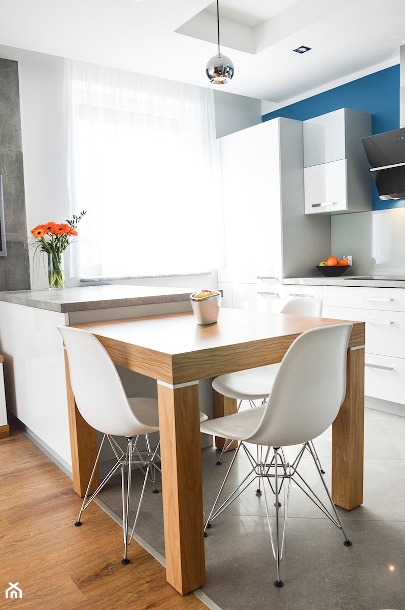 Mieszkanie dla mężczyzny - Mała z salonem z kamiennym blatem biała niebieska z zabudowaną lodówką kuchnia jednorzędowa z wyspą lub półwyspem, styl nowoczesny - zdjęcie od BWA-STUDIO