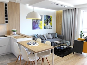 Nowoczesne mieszkanie w apartamentowcu, biel i szarość ocieplane drewnem - Mały biały salon z kuchnią z jadalnią, styl nowoczesny - zdjęcie od MK HOME