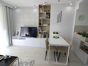 Eleganckie, nowoczesne, jasne mieszkanie w apartamentowcu - Średni biały szary salon z kuchnią z jadalnią z bibiloteczką, styl nowoczesny - zdjęcie od MK HOME