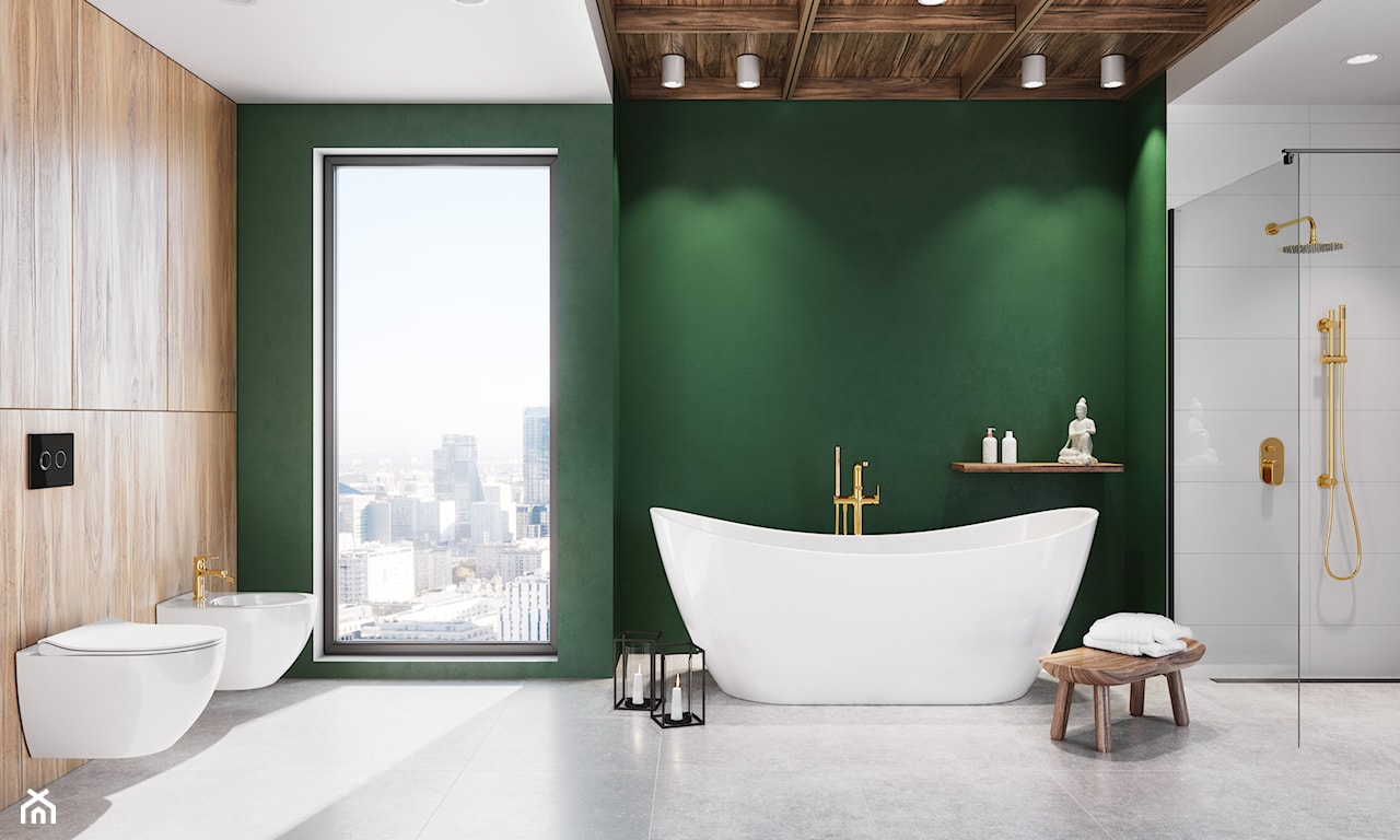 Łazienka z zieloną ścianą i złotą armaturą 
