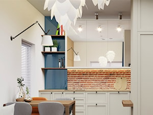 beżowa kuchnia z cegłą i lustrzanymi frontami - zdjęcie od JUKA design Pracownia Wnętrz