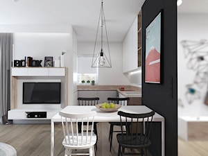 Duża biała czarna jadalnia w salonie w kuchni, styl nowoczesny - zdjęcie od PASS Architekci