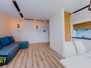 Mieszkanie pod wynajem - Średni biały salon z kuchnią z jadalnią, styl skandynawski - zdjęcie od OptimumArt Pracownia Aranżacji Wnętrz