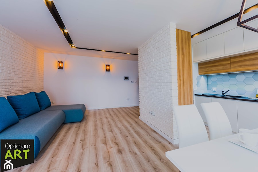 Mieszkanie pod wynajem - Średni biały salon z kuchnią z jadalnią, styl skandynawski - zdjęcie od OptimumArt Pracownia Aranżacji Wnętrz