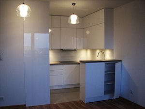 kuchnie lakierowane nowoczesne - Mała otwarta z salonem z kamiennym blatem biała z zabudowaną lodówką kuchnia w kształcie litery g z wyspą lub półwyspem, styl minimalistyczny - zdjęcie od Projekt-Kuchnie