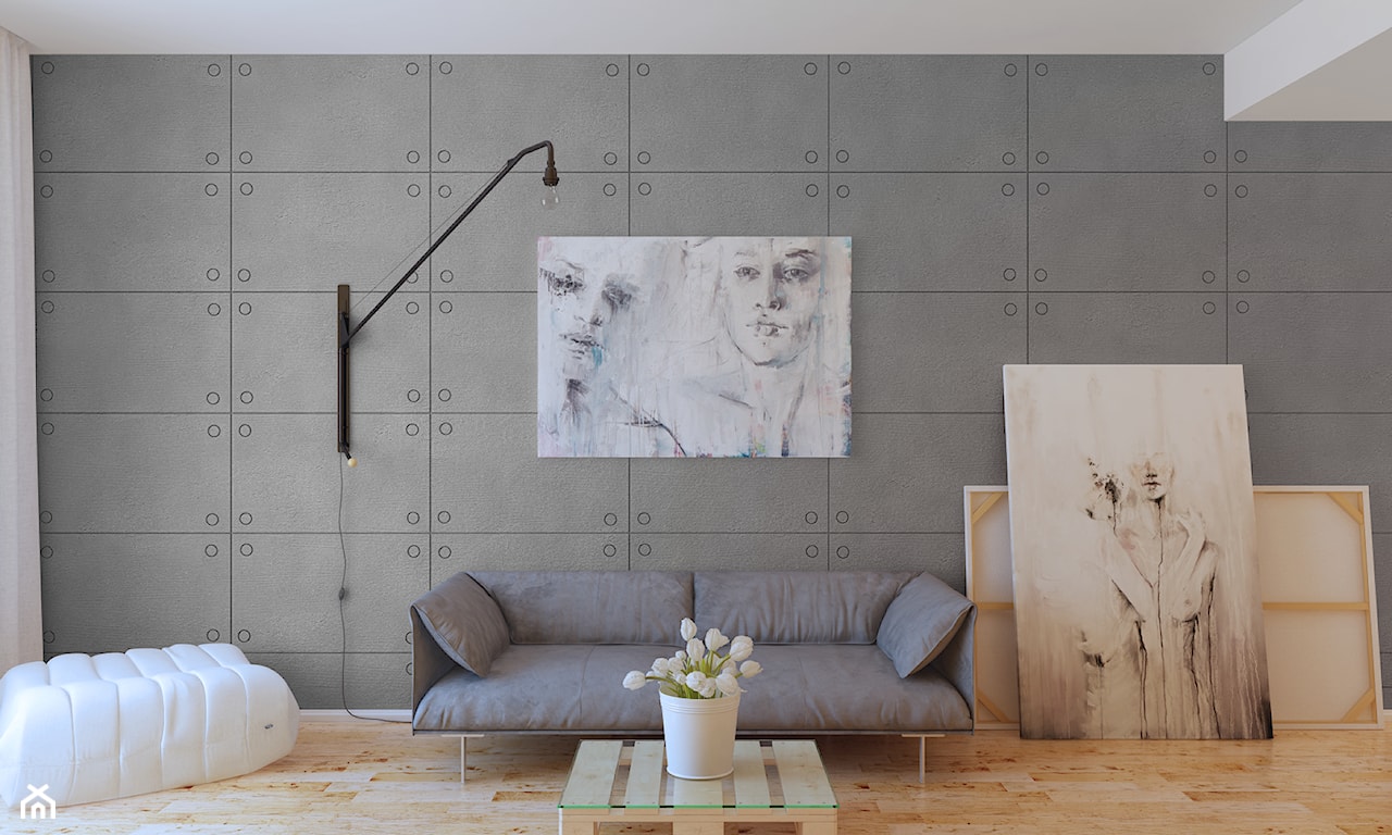 ściana z płyt betonowych, szara sofa, szkice sylwetek
