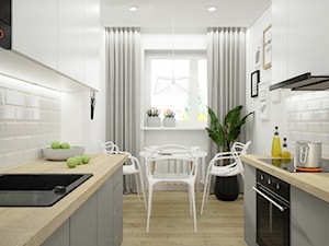 Remont mieszkania pod inwestycję - Mała zamknięta biała z zabudowaną lodówką z nablatowym zlewozmywakiem kuchnia dwurzędowa z oknem, styl skandynawski - zdjęcie od Wnętrza od NOWA