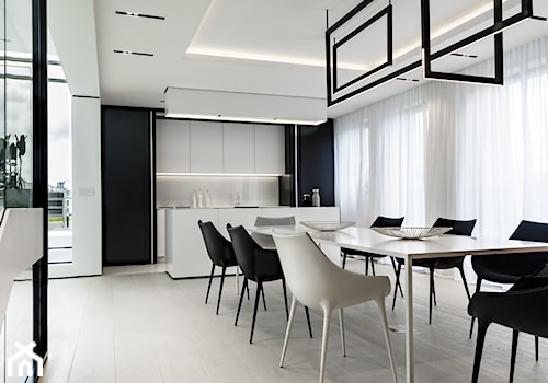 Minimalistyczny apartament Mokotów - Duża otwarta biała czarna z zabudowaną lodówką kuchnia dwurzędowa z oknem, styl minimalistyczny - zdjęcie od ON/OFF Architekci