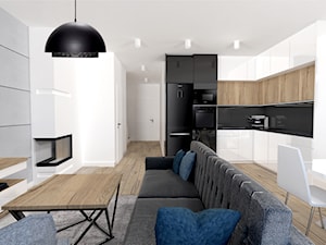 Minimalizm - Średnia otwarta z salonem z kamiennym blatem biała czarna z zabudowaną lodówką z lodówką wolnostojącą kuchnia w kształcie litery l, styl minimalistyczny - zdjęcie od MdoKwadratu