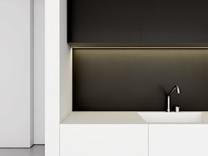 WNĘTRZA DOMU SZEREGOWEGO - Średnia biała czarna z zabudowaną lodówką z podblatowym zlewozmywakiem kuchnia, styl minimalistyczny - zdjęcie od INUTI