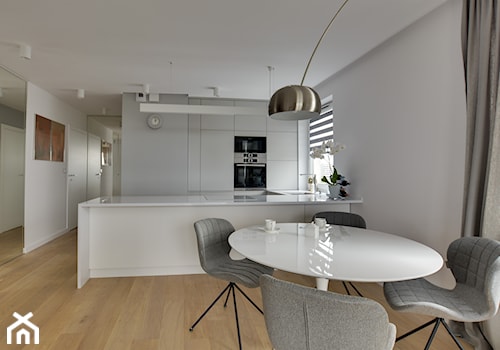 Mieszkanie wg autorstwa studia KAST DESIGN z Paryża - Duża biała jadalnia w kuchni, styl nowoczesny - zdjęcie od Radosław Sobik Fotografia