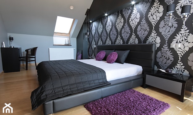 sypialnia w stylu glamour na poddaszu, drewniana podłoga, grafitowa narzuta, fioletowy dywan