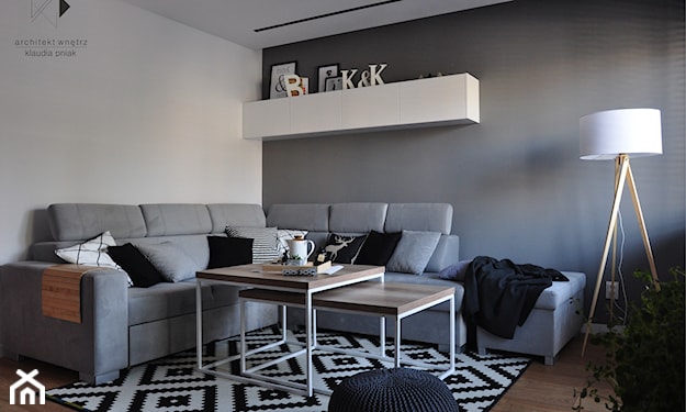 szary salon minimalistyczny, drewniany stolik z białymi nogami, biały dywan w czarne romby