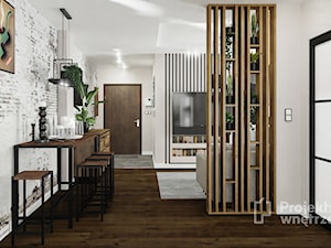 Mały salon z kuchnią jadalnią nowoczesny loft industrialny beżowy ciemne drewno czarny lamele PROJEKT: WNĘTRZE www.projektwnetrze.com.pl - zdjęcie od PROJEKT: WNĘTRZE