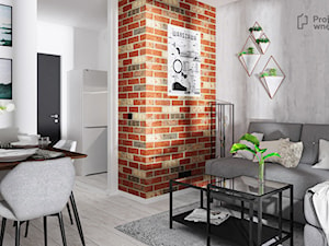 Mały szary salon z kuchnią jadalnią nowoczesny z narożnikiem cegła loft beton industrialny mikro apartament PROJEKT: WNĘTRZE www.projektwnetrze.com.pl - zdjęcie od PROJEKT: WNĘTRZE