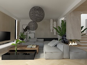 duży szary narożnik i drewniana ściana tv w dużym salonie z jadalnią i kominkiem elektrycznym - zdjęcie od Atelier 37 | architektura & projektowanie wnętrz