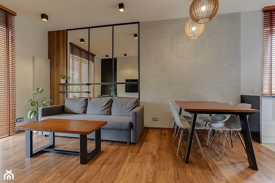 Minimalistyczna jadalnia z betonową ścianą otwarta na salon u kuchnię - zdjęcie od Atelier 37 | architektura & projektowanie wnętrz