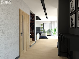 Parter domu w industrialno-loftowym wykończeniu - Średni czarny szary z farbą na ścianie z drzwiami przylgowymi z drewnianymi drzwiami z przeszklonymi drzwiami z gładkimi drzwiami hol / przedpokój, styl industrialny - zdjęcie od Strzelecka Design