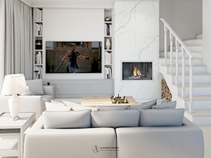 Jasny salon z marmurowym kominkiem - zdjęcie od Auroom Concept