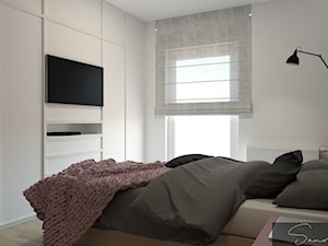 Sypialnia z tapicerowaną ścianą oraz fototapetą z motywem roślinnym - zdjęcie od sandroom