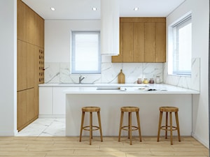 Białą kuchnia z dodatkiem drewna - zdjęcie od MACZ Architektura