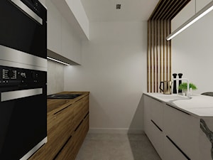 Apartament z ukrytymi drzwiami - Średnia otwarta szara z zabudowaną lodówką kuchnia dwurzędowa, styl minimalistyczny - zdjęcie od Reforma Domu