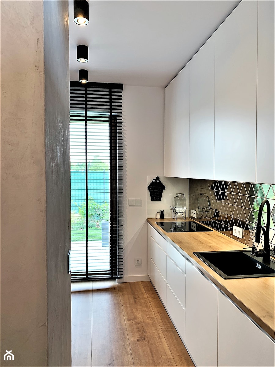 Niewielki dom na Maślicach - realizacja projektu - Mała otwarta z salonem biała czarna z zabudowaną lodówką z nablatowym zlewozmywakiem kuchnia jednorzędowa z oknem, styl nowoczesny - zdjęcie od DekoDeko