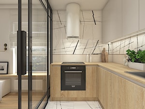 Mieszkanie w krakowie 50 m2 - Mała otwarta z salonem szara z zabudowaną lodówką z nablatowym zlewozmywakiem kuchnia w kształcie litery l z oknem z marmurem nad blatem kuchennym, styl nowoczesny - zdjęcie od WERDHOME