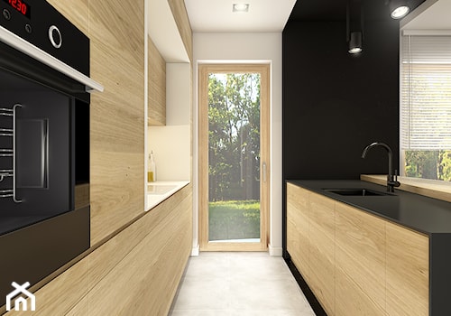Dom pod Wolbromiem - Średnia zamknięta biała czarna z zabudowaną lodówką z podblatowym zlewozmywakiem kuchnia dwurzędowa, styl minimalistyczny - zdjęcie od WERDHOME